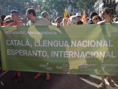 Fotografía de la manifestación de Òmnium Cultural en Barcelona, el 10 de Julio de 2010, con un cartel reivindicador del esperanto. Fotografía gentileza de Llibert Puig, Ferriol Macip y la Asociación Catalana de Esperanto.